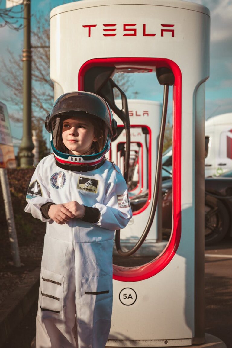 boy in helmet standing by tesla charger